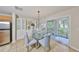 Cozy dining area with glass table and access to the outdoor patio at 618 Wheaton Trent Pl, Tampa, FL 33619