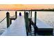 A serene dock at sunset, perfect for quiet contemplation with a backdrop of a distant city skyline at 618 Wheaton Trent Pl, Tampa, FL 33619