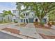 Attractive townhome with well-maintained landscaping, blue garage doors, and inviting archways, capturing curb appeal at 618 Wheaton Trent Pl, Tampa, FL 33619