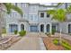 Attractive townhome with well-maintained landscaping, blue garage doors, and inviting archways, capturing curb appeal at 618 Wheaton Trent Pl, Tampa, FL 33619
