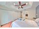A primary bedroom featuring a ceiling fan, closets and wood floors at 618 Wheaton Trent Pl, Tampa, FL 33619