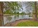 Scenic pond view framed by lush greenery and mature trees, offering a tranquil and picturesque setting at 618 Wheaton Trent Pl, Tampa, FL 33619