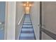 Staircase with blue stairs leading to upper floors at 618 Wheaton Trent Pl, Tampa, FL 33619