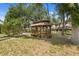 Backyard featuring a wooden gazebo and mature trees at 6213 S Queensway Dr, Temple Terrace, FL 33617