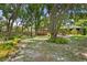Lush backyard with a charming gazebo and inviting patio, creating a serene and relaxing outdoor space at 6213 S Queensway Dr, Temple Terrace, FL 33617