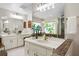 Bathroom featuring dual vanities, decorative tile accents, and a large mirror at 6213 S Queensway Dr, Temple Terrace, FL 33617