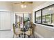 Dining area showcasing elegant glass table, stylish chairs, and natural light from large windows at 6213 S Queensway Dr, Temple Terrace, FL 33617