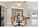 Dining area with a glass table, decorative chairs, and sliding glass doors to the outdoor area at 6213 S Queensway Dr, Temple Terrace, FL 33617