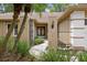 Inviting front entrance with lush tropical landscaping, leading to an elegant home at 6213 S Queensway Dr, Temple Terrace, FL 33617