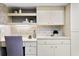 Home office featuring built-in shelving, modern lighting, and ample counter space for productivity at 6213 S Queensway Dr, Temple Terrace, FL 33617