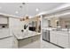 Well-appointed kitchen with granite countertops, island, and stainless steel appliances seamlessly blends style with functionality at 6213 S Queensway Dr, Temple Terrace, FL 33617