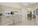 Modern kitchen with white cabinetry, stainless steel appliances, and granite countertops is ideal for cooking and entertaining at 6213 S Queensway Dr, Temple Terrace, FL 33617
