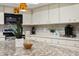 Well-lit kitchen with granite countertops, modern appliances, and decorative pendant lighting at 6213 S Queensway Dr, Temple Terrace, FL 33617