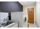 Laundry room featuring modern washer and dryer, sink, and bright accents at 6213 S Queensway Dr, Temple Terrace, FL 33617