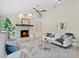 Cozy living room features stone fireplace, neutral colors and plush seating offering warmth and comfort at 6213 S Queensway Dr, Temple Terrace, FL 33617