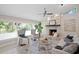 Bright and airy living room with stone fireplace, large windows, and stylish decor at 6213 S Queensway Dr, Temple Terrace, FL 33617