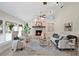 Bright living room featuring a stone fireplace, large windows, and neutral decor at 6213 S Queensway Dr, Temple Terrace, FL 33617