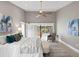 Spacious main bedroom with stylish decor, high ceilings, and sliding glass doors to the lanai at 6213 S Queensway Dr, Temple Terrace, FL 33617
