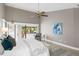 Spacious main bedroom with stylish decor, high ceilings, and sliding glass doors to the lanai at 6213 S Queensway Dr, Temple Terrace, FL 33617