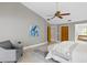 Spacious main bedroom with stylish chair, ensuite bathroom and walk-in closet at 6213 S Queensway Dr, Temple Terrace, FL 33617