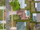A high definition aerial view showcasing the property, a private in-ground pool, a driveway and a well manicured lawn at 6352 Huntington Dr, Zephyrhills, FL 33542
