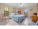 Bedroom featuring a bed and tiled flooring at 6352 Huntington Dr, Zephyrhills, FL 33542
