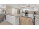 Bright eat-in kitchen featuring white cabinets, stainless steel appliances and a breakfast bar at 6352 Huntington Dr, Zephyrhills, FL 33542