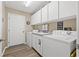Laundry room with washer, dryer, sink and storage cabinets at 6352 Huntington Dr, Zephyrhills, FL 33542