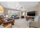 Cozy living room with large bay window, plush carpeting, and comfortable seating, ideal for relaxation at 6352 Huntington Dr, Zephyrhills, FL 33542