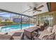 Outdoor covered patio with comfortable seating area overlooking the refreshing private pool at 6352 Huntington Dr, Zephyrhills, FL 33542