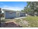 Cozy backyard features a patio, a tree and a blue house at 6481 64Th N Ave, Pinellas Park, FL 33781