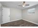 Bright bedroom with wood-look flooring, ceiling fan, and a window for natural light at 6481 64Th N Ave, Pinellas Park, FL 33781