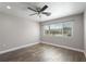 Serene bedroom with hardwood floors, ceiling fan, and a large window at 6481 64Th N Ave, Pinellas Park, FL 33781
