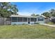 Charming single Gathering home with a screened in front porch and a well-maintained lawn at 6481 64Th N Ave, Pinellas Park, FL 33781