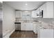 Modern kitchen with stainless steel appliances, white cabinets, and granite countertops at 6481 64Th N Ave, Pinellas Park, FL 33781