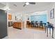 Bright kitchen and dining area featuring light-colored terrazzo floors and a view into the formal dining room at 6677 Poinsettia S Ave, St Petersburg, FL 33707
