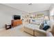 Bright living room showcasing a large sectional couch, neutral walls, and terrazzo flooring at 6677 Poinsettia S Ave, St Petersburg, FL 33707
