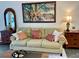 Cozy living room featuring a plush sofa, colorful artwork, and stylish decor at 6677 Poinsettia S Ave, St Petersburg, FL 33707