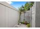 Private outdoor shower featuring wood paneling, a sun decor accent, and natural vegetation at 6677 Poinsettia S Ave, St Petersburg, FL 33707