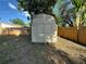 Backyard features a convenient storage shed with a double door and a wooden fence at 6982 79Th N Ave, Pinellas Park, FL 33781