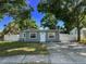 Charming home features a freshly painted exterior, a well-manicured lawn, and a white fence at 6982 79Th N Ave, Pinellas Park, FL 33781