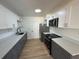 Modern kitchen with two-tone cabinets, stainless steel appliances, quartz countertops, and stylish fixtures at 6982 79Th N Ave, Pinellas Park, FL 33781