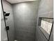 Contemporary shower with gray tile, a black shower head and mosaic tile decor at 6982 79Th N Ave, Pinellas Park, FL 33781