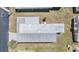 Aerial view of the mobile home featuring a white roof and green surrounding structures at 7045 El Dewitt St, Zephyrhills, FL 33541