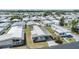 Aerial view of a mobile home in a well-organized community with lush green spaces at 7045 El Dewitt St, Zephyrhills, FL 33541