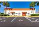 Community center with an orange tile roof, matching awnings, clearly-marked accessible parking, and blue sky at 7045 El Dewitt St, Zephyrhills, FL 33541