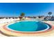 Community pool with a brick coping, and multiple entry points at Spanish Trails Senior Village at 7045 El Dewitt St, Zephyrhills, FL 33541