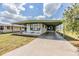 Single Gathering home with a long driveway and a covered carport at 7045 El Dewitt St, Zephyrhills, FL 33541