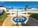 Community hot tub with wooden surround is great for relaxing with Gathering and friends at 7045 El Dewitt St, Zephyrhills, FL 33541