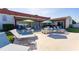 Community patio with lounge chairs, tables and umbrellas for residents to enjoy at 7045 El Dewitt St, Zephyrhills, FL 33541